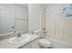Well-lit bathroom featuring a single vanity, toilet, and shower-tub combo at 1502 Deer Springs Rd, Port Orange, FL 32129