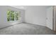 Bedroom features a large window with view and neutral carpet at 1502 Deer Springs Rd, Port Orange, FL 32129