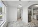 Bright dining area with tile flooring, modern lighting, and an open view leading to the staircase and kitchen at 1502 Deer Springs Rd, Port Orange, FL 32129