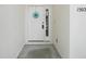 Welcoming entryway featuring a white door adorned with a decorative floral wreath, creating a warm invitation at 1502 Deer Springs Rd, Port Orange, FL 32129