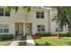 Charming townhome featuring a welcoming front facade with a well-manicured lawn and verdant shrubbery at 1502 Deer Springs Rd, Port Orange, FL 32129