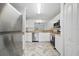 Modern kitchen features stainless steel appliances, white cabinetry, and stylish flooring for a sleek, contemporary feel at 1502 Deer Springs Rd, Port Orange, FL 32129