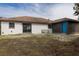 Exterior view of the backyard showing a sliding door and a blue entryway at 1744 Valencia Ave, Ormond Beach, FL 32174