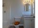 Bright bathroom featuring a shower, toilet with a wooden seat, and a vanity with granite countertop at 1744 Valencia Ave, Ormond Beach, FL 32174