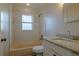 Updated bathroom with marble-style tiling, a bathtub, and a vanity with a granite countertop at 1744 Valencia Ave, Ormond Beach, FL 32174