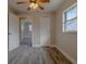 Cozy bedroom with wood-look floors, a ceiling fan, a window, and a closet for ample storage at 1744 Valencia Ave, Ormond Beach, FL 32174