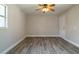 Spacious bedroom features wood-look flooring, a ceiling fan, and natural light from the window at 1744 Valencia Ave, Ormond Beach, FL 32174