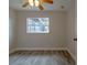 Comfortable bedroom with wood-look floors, a window, and a door leading to other rooms at 1744 Valencia Ave, Ormond Beach, FL 32174