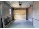 Spacious garage with a large door, concrete floor, and natural light from the window at 1744 Valencia Ave, Ormond Beach, FL 32174