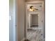Long hallway with hardwood floors leading to a bedroom with a ceiling fan and natural light at 1744 Valencia Ave, Ormond Beach, FL 32174