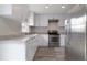 Bright kitchen with stainless steel appliances, granite countertops, and white cabinets at 1744 Valencia Ave, Ormond Beach, FL 32174