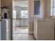 Functional laundry area with washer, dryer, and access to a bright kitchen with modern appliances at 1744 Valencia Ave, Ormond Beach, FL 32174