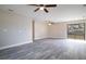 Spacious living room with hardwood floors, two fans, and a sliding door leading to the backyard at 1744 Valencia Ave, Ormond Beach, FL 32174