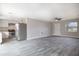 An open-concept living area featuring stainless steel appliances, hardwood floors, and white kitchen cabinets at 1744 Valencia Ave, Ormond Beach, FL 32174
