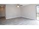 An open-concept living area featuring hardwood floors, freshly painted walls, and a sliding door at 1744 Valencia Ave, Ormond Beach, FL 32174
