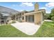 Home exterior showcasing a large backyard, patio, and screened-in pool area at 1766 Roscoe Turner Trl, Port Orange, FL 32128