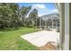 Backyard featuring a concrete patio and a screened-in lanai with a pool and seating area at 1766 Roscoe Turner Trl, Port Orange, FL 32128