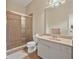 Bathroom featuring a tiled shower with glass doors, toilet, and a vanity sink at 1766 Roscoe Turner Trl, Port Orange, FL 32128