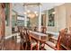 Spacious dining room with hardwood floors, white columns, and stylish chandelier at 1766 Roscoe Turner Trl, Port Orange, FL 32128