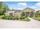 Elegant home exterior with columned entry, mature palms and circular driveway at 1766 Roscoe Turner Trl, Port Orange, FL 32128