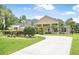 Stunning home with a long driveway, well-manicured lawn, and beautiful landscaping at 1766 Roscoe Turner Trl, Port Orange, FL 32128