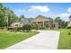 Beautiful home with lush lawn, mature trees, and a circular driveway at 1766 Roscoe Turner Trl, Port Orange, FL 32128