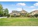 Stately exterior featuring a well-manicured lawn and mature landscaping at 1766 Roscoe Turner Trl, Port Orange, FL 32128