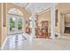 Elegant foyer featuring high ceilings, large windows, and a view of the dining room at 1766 Roscoe Turner Trl, Port Orange, FL 32128
