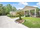 Charming two-story home featuring a well-manicured lawn, long driveway, and lovely landscaping at 1766 Roscoe Turner Trl, Port Orange, FL 32128