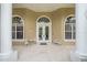 Elegant front porch featuring comfortable seating and grand entrance at 1766 Roscoe Turner Trl, Port Orange, FL 32128