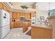 Bright kitchen with wood cabinets, island, stainless steel appliances, and tiled floor at 1766 Roscoe Turner Trl, Port Orange, FL 32128