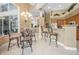 Open kitchen and dining area with breakfast bar, chandelier, and ample seating at 1766 Roscoe Turner Trl, Port Orange, FL 32128