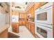 Gourmet kitchen featuring custom cabinets and modern stainless steel appliances at 1766 Roscoe Turner Trl, Port Orange, FL 32128