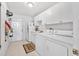 Well-lit laundry room with appliances and storage cabinets at 1766 Roscoe Turner Trl, Port Orange, FL 32128