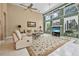Spacious living room with large windows, high ceilings, neutral paint and ceiling fans at 1766 Roscoe Turner Trl, Port Orange, FL 32128