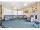 Cozy living room featuring a large sectional sofa, fireplace, and sliding glass doors leading to the backyard at 1766 Roscoe Turner Trl, Port Orange, FL 32128