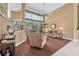Bright living room with high ceilings, large windows, plush furniture, and neutral carpet at 1766 Roscoe Turner Trl, Port Orange, FL 32128