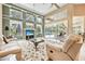 Bright living room with large windows, high ceilings, and view of the outdoor pool area at 1766 Roscoe Turner Trl, Port Orange, FL 32128