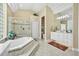 Bright main bathroom featuring a large tub, walk-in shower, and dual vanities at 1766 Roscoe Turner Trl, Port Orange, FL 32128