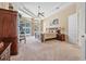 Spacious main bedroom featuring tray ceilings and sliding glass doors to the pool area at 1766 Roscoe Turner Trl, Port Orange, FL 32128