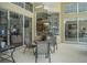 Covered patio with seating area overlooking the pool, and glimpses of kitchen and living areas at 1766 Roscoe Turner Trl, Port Orange, FL 32128