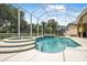 Screened-in pool and spa area, with lush landscaping and private backyard at 1766 Roscoe Turner Trl, Port Orange, FL 32128