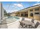 Large screened-in pool area with spa and outdoor seating area at 1766 Roscoe Turner Trl, Port Orange, FL 32128
