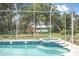 Screened-in pool and spa featuring blue tile accents and a beautiful lake view at 1766 Roscoe Turner Trl, Port Orange, FL 32128