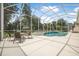 Screened-in pool and spa area with view of lake and natural surroundings at 1766 Roscoe Turner Trl, Port Orange, FL 32128