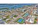 An aerial view of the community with tennis courts, various styles of homes and a view of the water at 3828 S Atlantic Ave, Daytona Beach, FL 32118