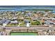 An aerial view shows the house with an extra-long driveway in a neighborhood near a body of water at 3828 S Atlantic Ave, Daytona Beach, FL 32118