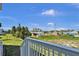 Backyard view from the deck, overlooking lush greenery, a chainlink fence and neighborhood houses at 3828 S Atlantic Ave, Daytona Beach, FL 32118