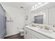 Bathroom featuring a double vanity, large mirror, and a shower with a blue patterned curtain at 3828 S Atlantic Ave, Daytona Beach, FL 32118