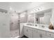 Bathroom showing a dual sink vanity and large walk-in shower at 3828 S Atlantic Ave, Daytona Beach, FL 32118
